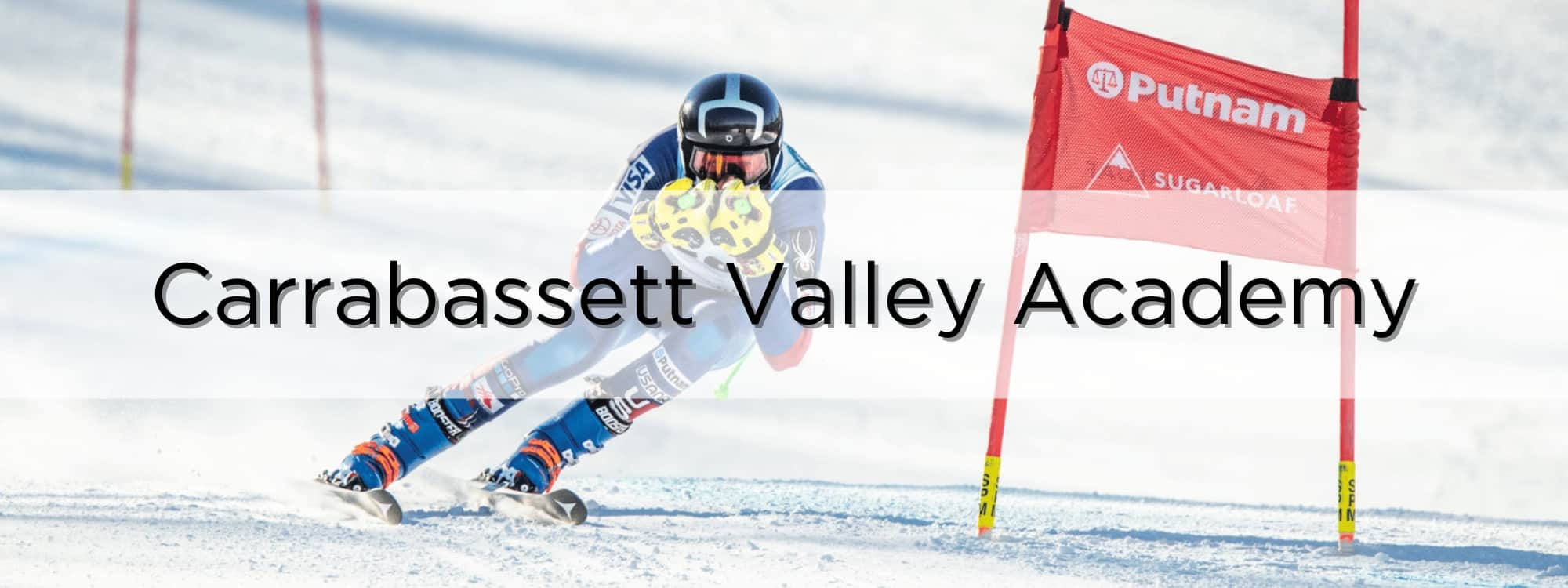Carrabassett Valley Academy-CVA-Ski racer carving around a gate at Sugarloaf, Maine.